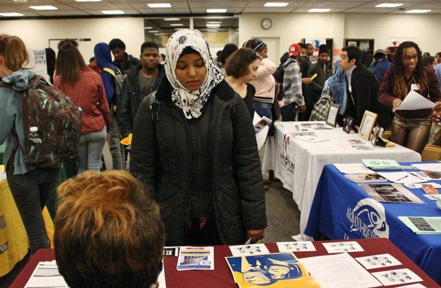 A student examines a kiosk during the black history month celebration