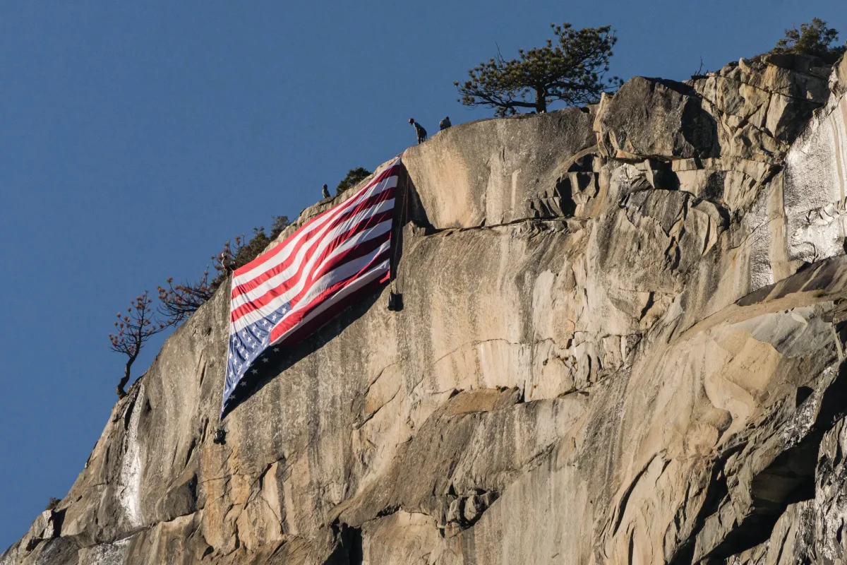 Sourced from The New York Times, an article about a protest at Yosemite National Park, "Organizers said the inverted flag, historically used as a sign of distress, was meant to draw attention to the Trump administration’s cuts to the National Park Service."